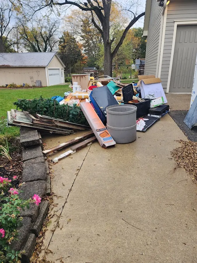 Dumpster being loaded with debris for Estate Cleanout Dumpster Rental in Summerfield